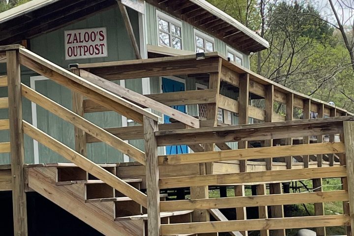 a wooden bench in front of a building
