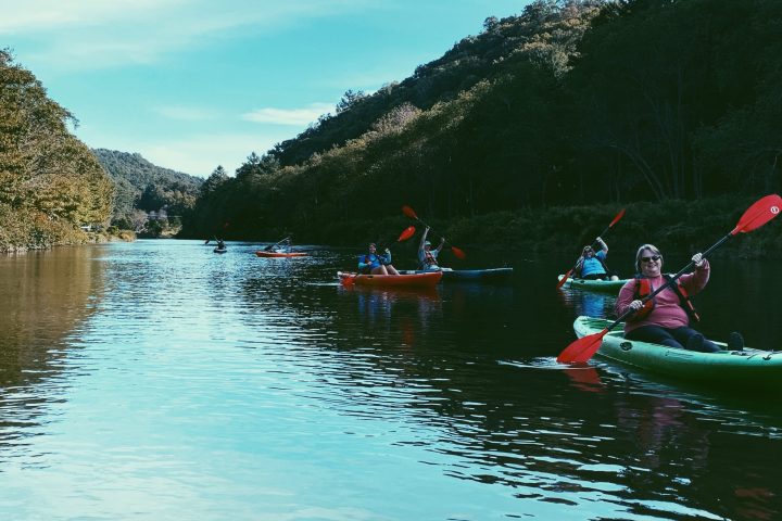 a group of people in a small boat in a body of water