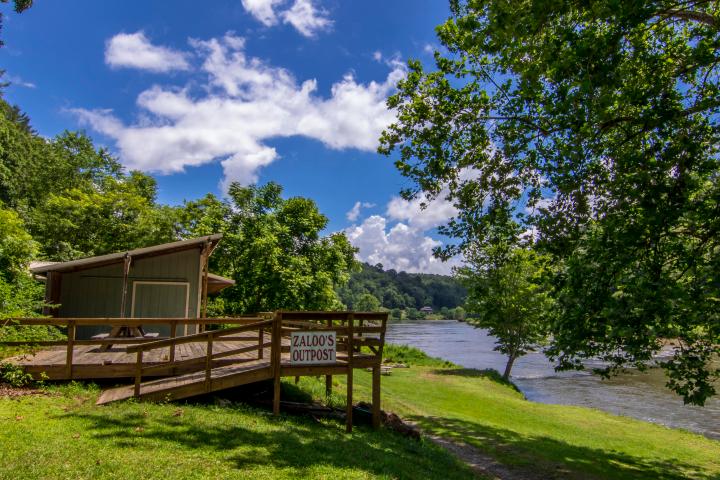 a bench sits in the middle of a lush green field
